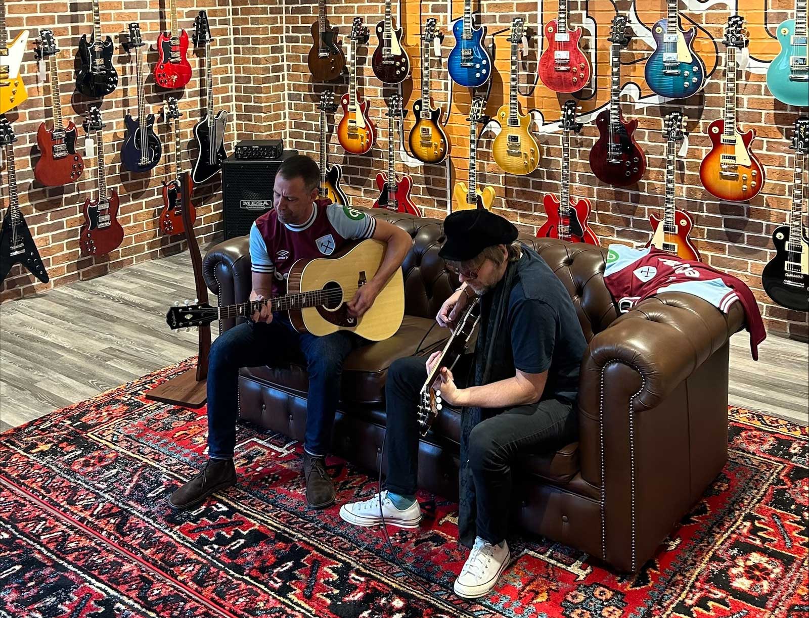 Joel Stoker (L) performing at the Gibson Garage in London while wearing this season's Home Kit.jpeg