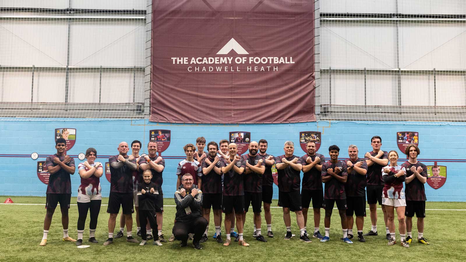 The Lyca Mobile Fan Plan player experience winners pose in front of an Academy of Football sign