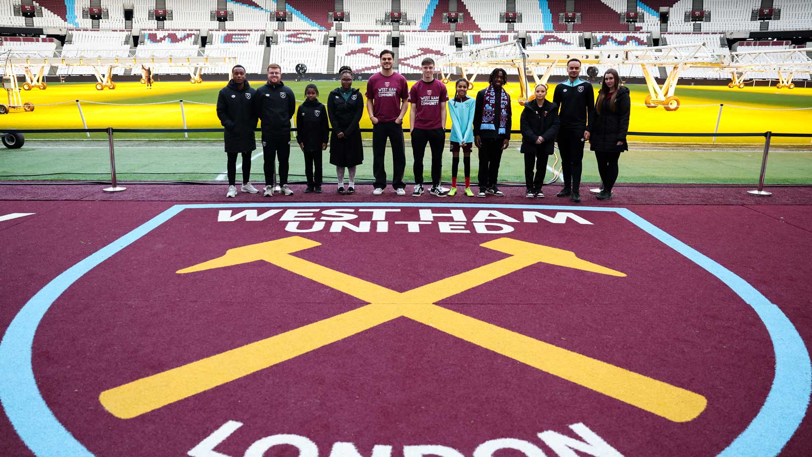 Ollie Scarles and Dinos Mavropanos with Moore Family Foundation participants at London Stadium