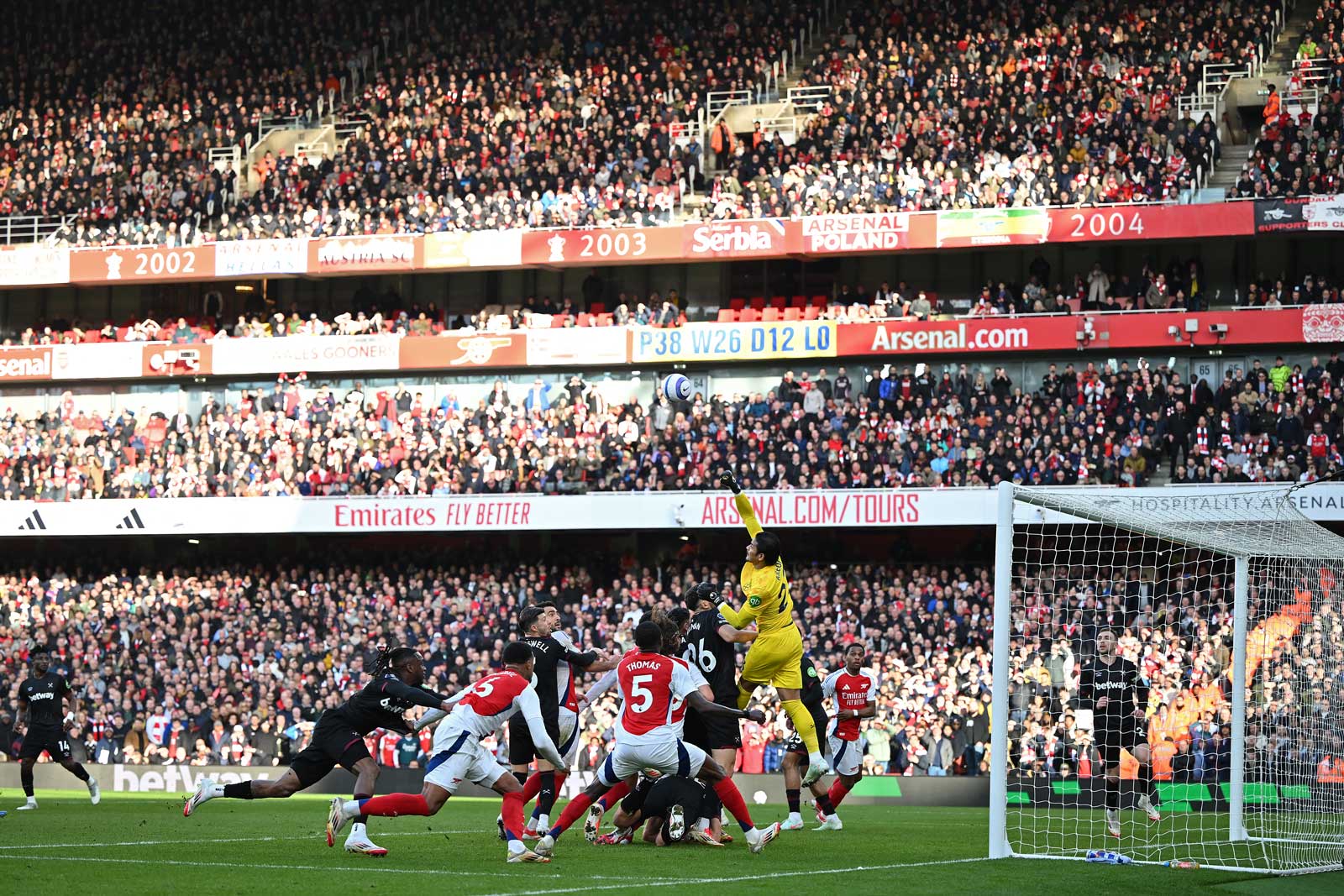 Alphonse Areola punches clear in a crowded box at Arsenal