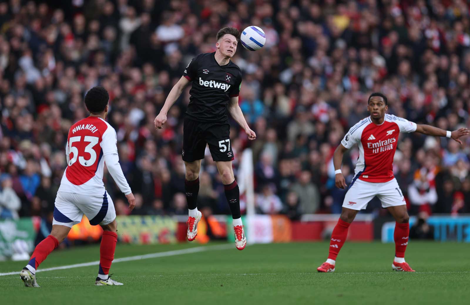 Ollie Scarles jumps to win a header against Arsenal