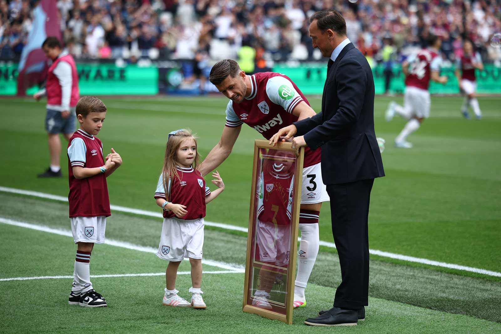 Aaron Cresswell is presented with a special shirt to mark his eleven years as a Hammer