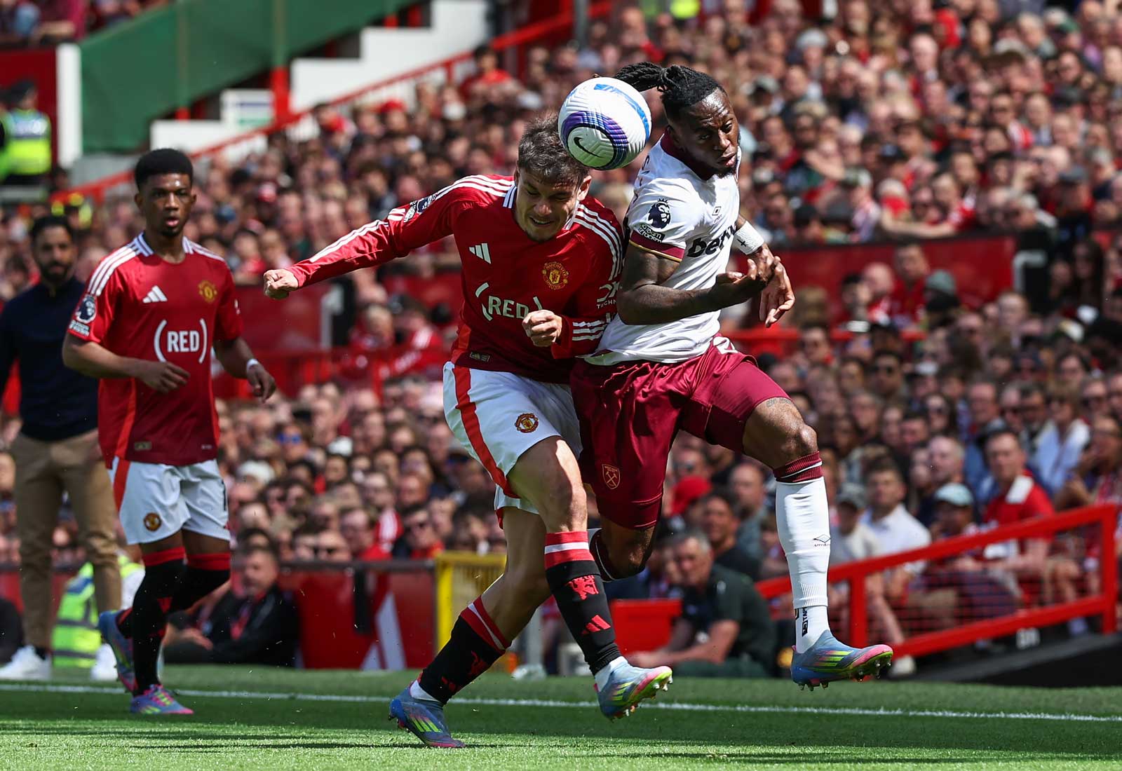 Aaron Wan-Bissaka battles with Manchester United's Manuel Ugarte