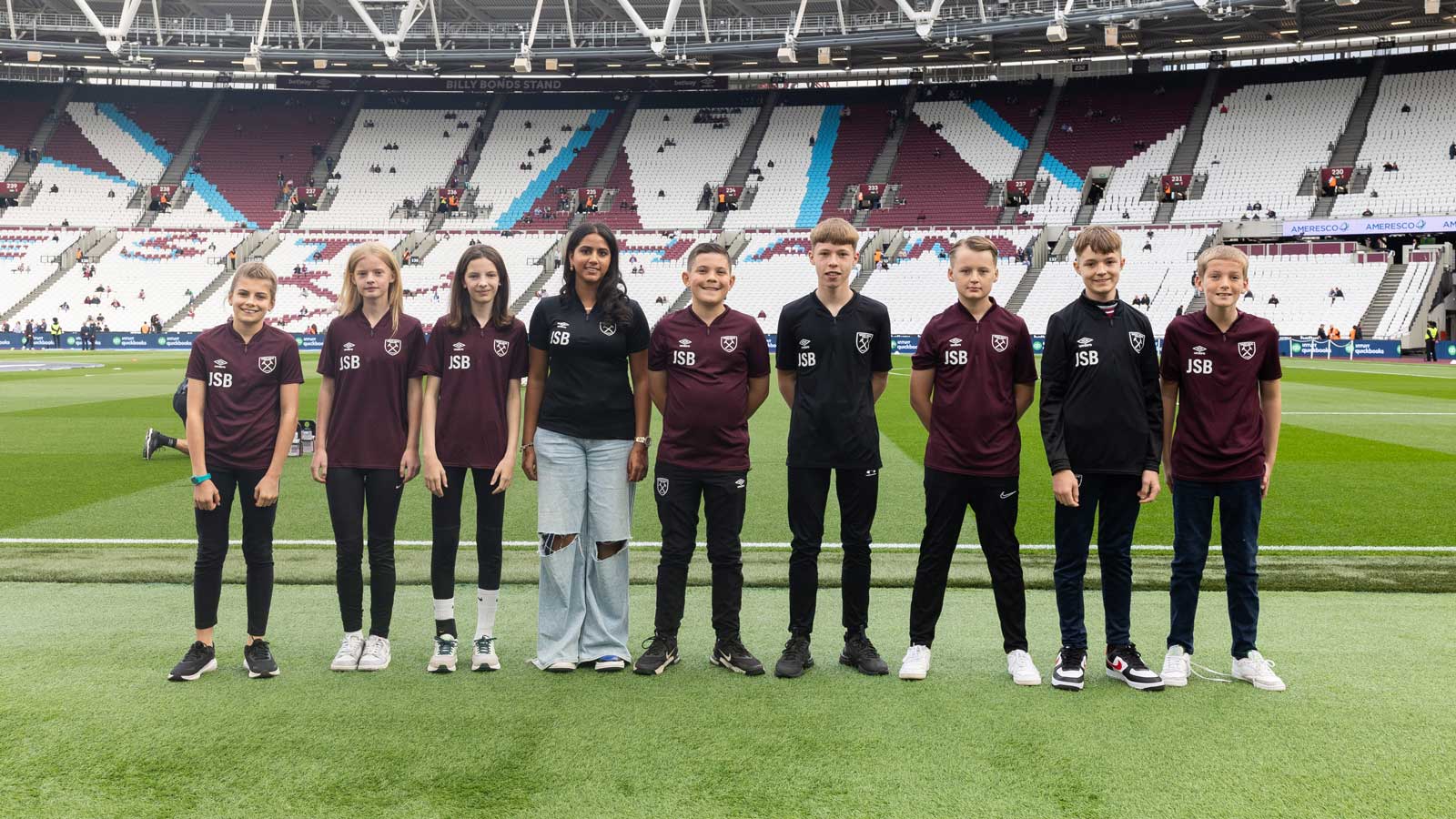 Members of the Junior Supporters' Board pitchside at London Stadium