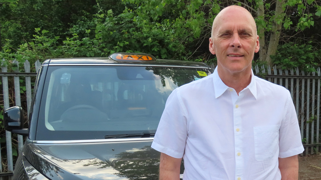 Alan Dickens with his taxi