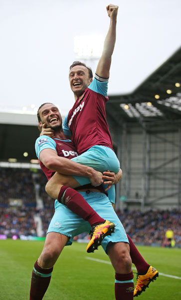 Andy Carroll celebrates a goal with Mark Noble at West Bromwich Albion