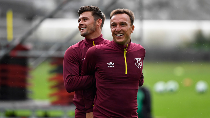 Aaron Cresswell shares a joke with captain Mark Noble during training in Switzerland