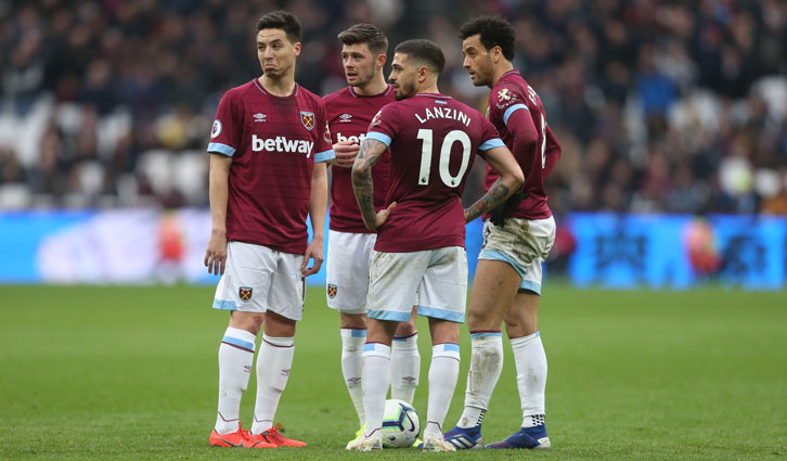 West Ham players stand over a free-kick