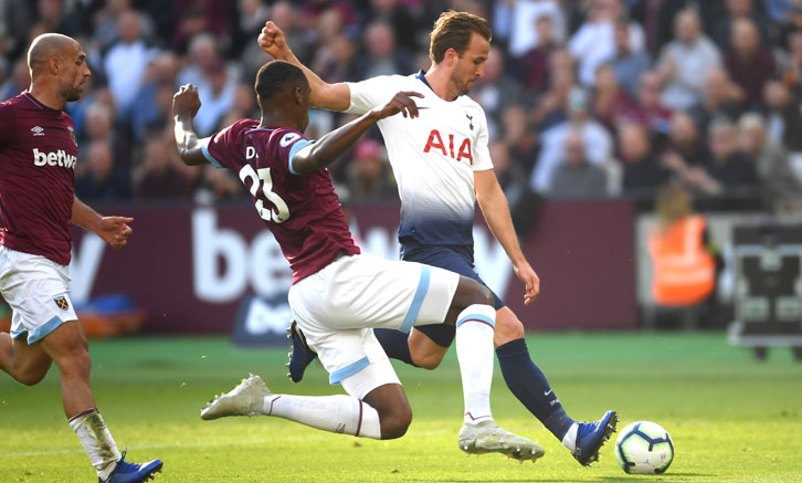 Issa Diop blocks a shot from Harry Kane