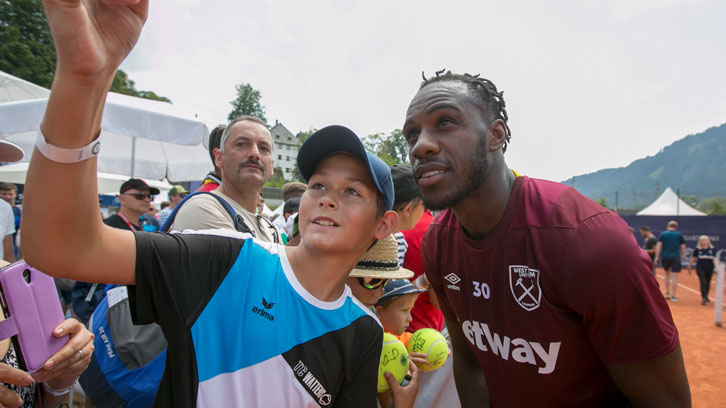 Michail Antonio poses for a selfie with a supporter