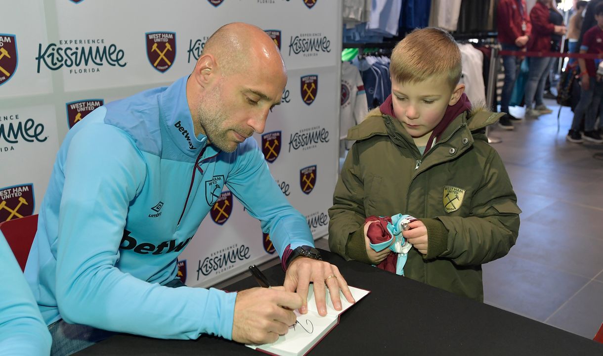 Pablo Zabaleta signs an autograph for a young fan