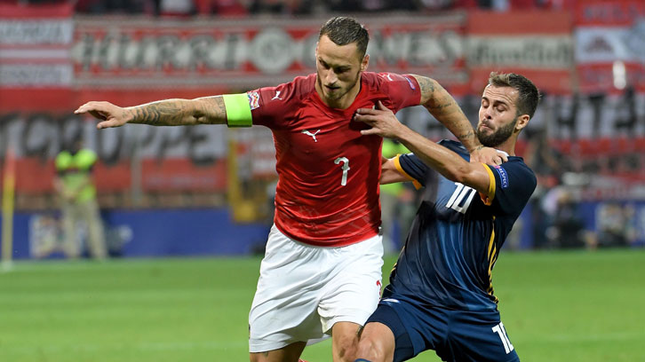 Marko Arnautovic holds off Bosnia and Herzegovina midfielder Miralem Pjanic