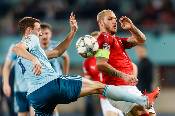 Marko Arnautovic is challenged by Jonny Evans