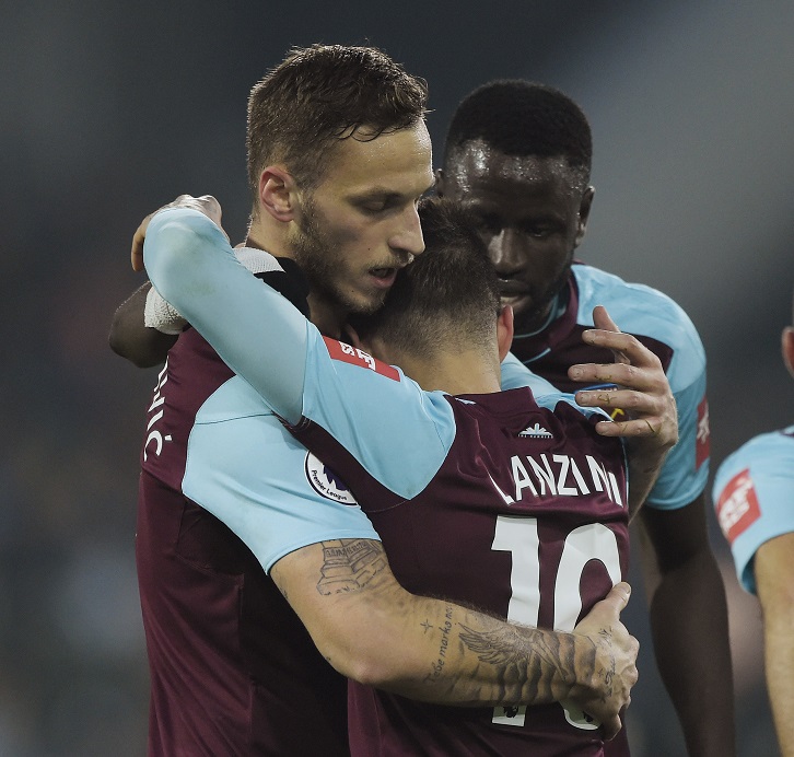 Marko Arnautovic and Manuel Lanzini embrace at Huddersfield Town