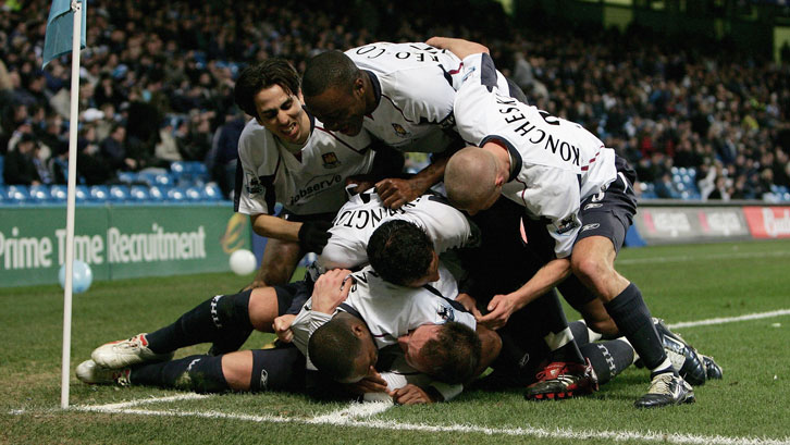 Dean Ashton is mobbed after scoring West Ham United's second goal at Manchester City