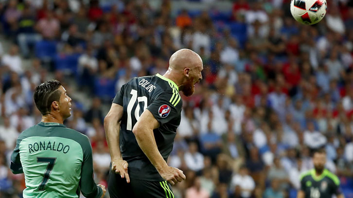 James Collins heads clear ahead of Cristiano Ronaldo