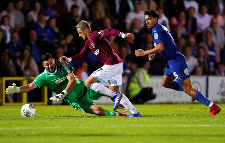 Chicharito rounds Tom King to score the Hammers' third goal at AFC Wimbledon