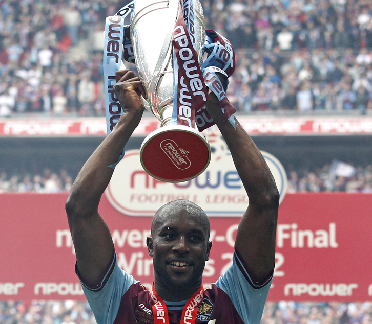 Carlton Cole holds the Play-Off trophy aloft