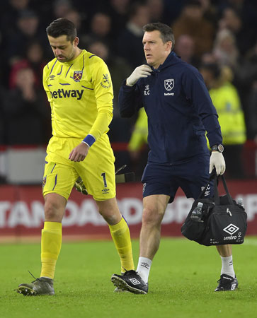 Richard Collinge tends to Lukasz Fabianski