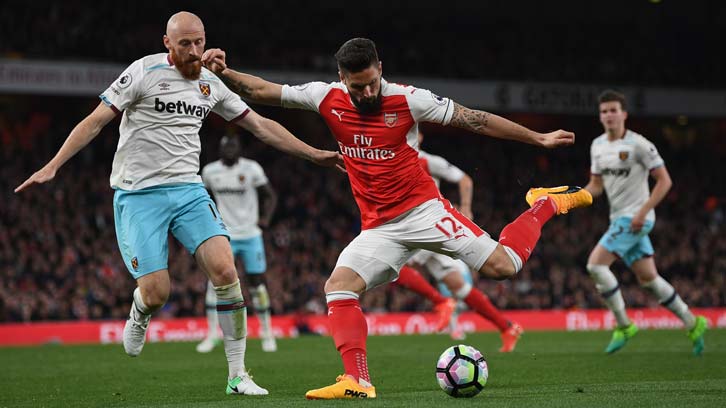 James Collins tries to block from Olivier Giroud