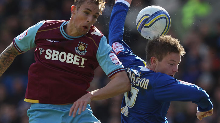 Jack Collison challenges Cardiff City's Aron Gunnarsson for the ball