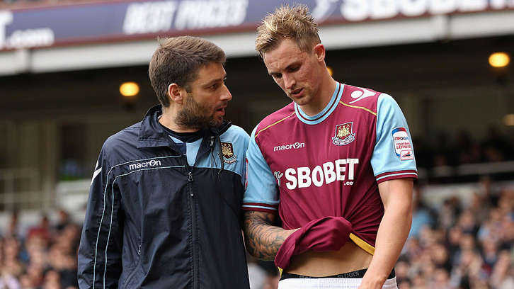 Jack Collison holds his arm after it popped out in the semi-final