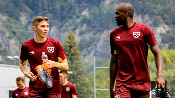Conor Coventry talks to Angelo Ogbonna following a training session in Switzerland