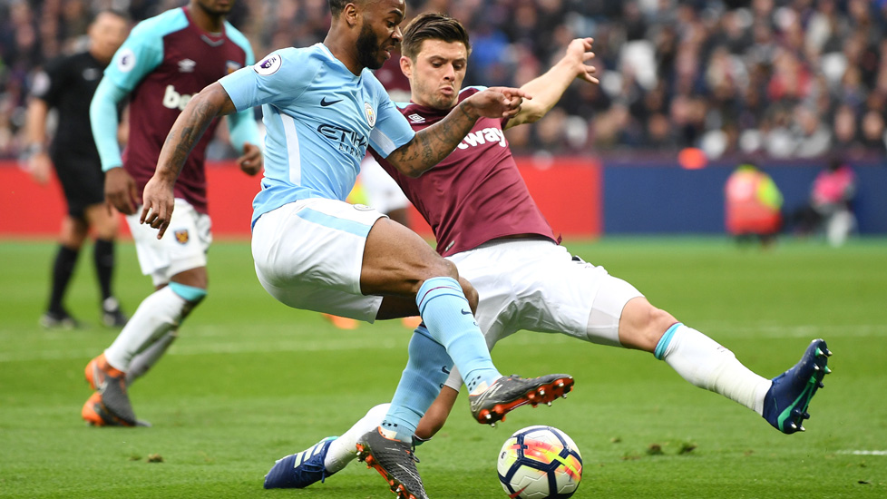 Aaron Cresswell challenges Raheem Sterling