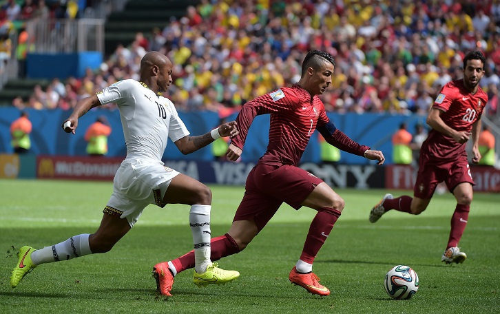 Andre Ayew and Cristiano Ronaldo in action at the 2014 FIFA World Cup finals