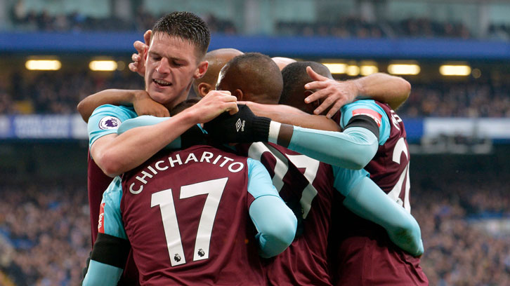 Chicharito is mobbed by his teammates after equalising at Stamford Bridge