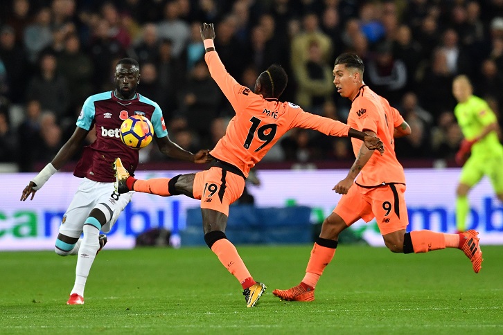 Cheikhou Kouyate and Sadio Mane battle for possession