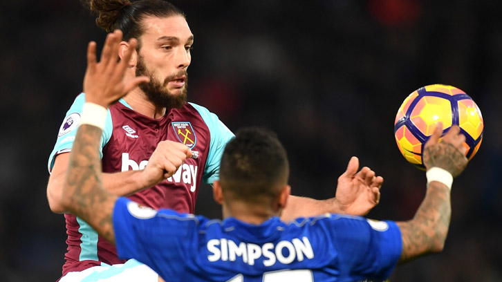 Andy Carroll challenges Leicester City's Danny Simpson