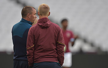 Liam Manning and Steve Potts converse during the London derby