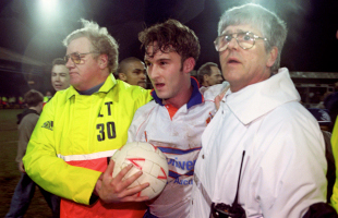 Scott Oakes walks off the pitch with the match ball