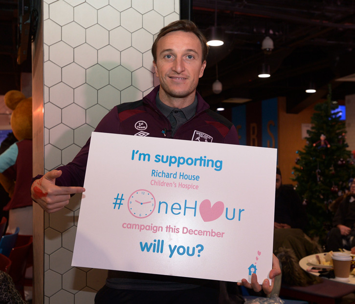 Mark Noble with a card supporting the Richard House #OneHour campaign