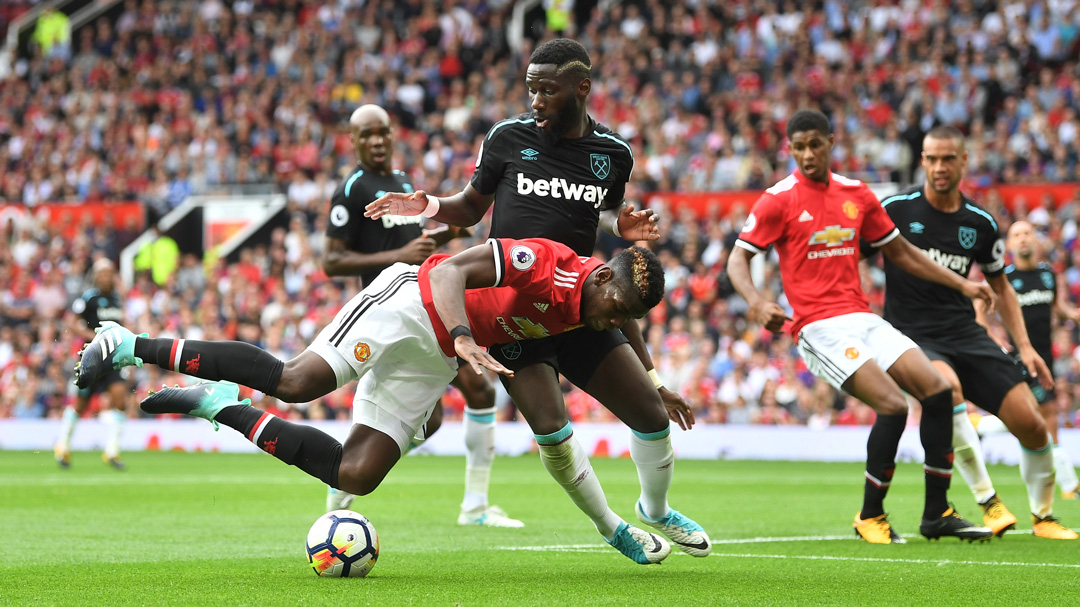 Arthur Masuaku challenges Manchester United's Paul Pogba