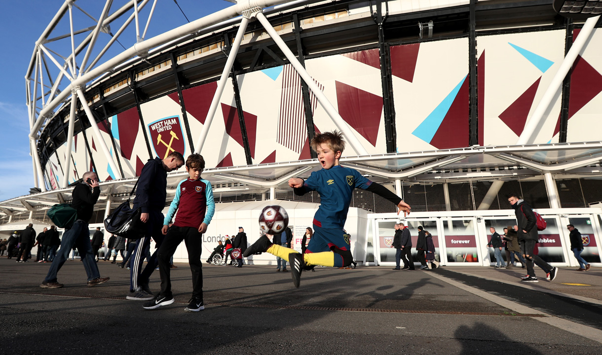 Children play football outside London Stadium