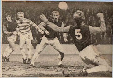 Bobby Moore looks on as Tommy Taylor makes a clearance