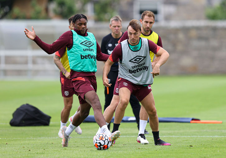 Mark Noble, 34, challenges Jamal Baptiste, 17, in pre-season training