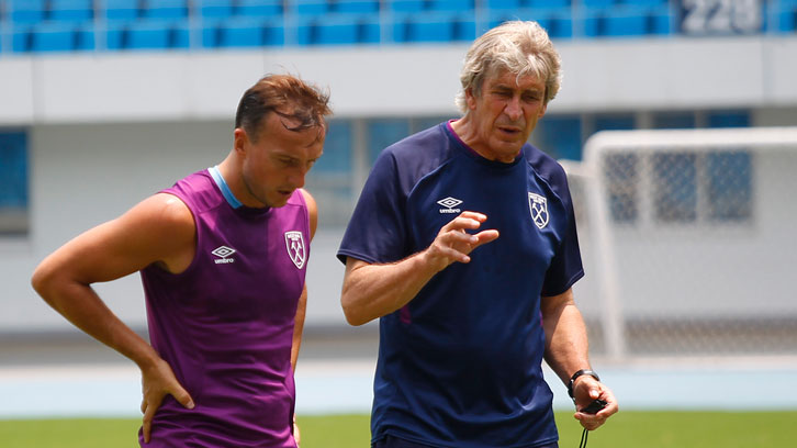 Mark Noble and Manuel Pellegrini chat on the training pitch in China