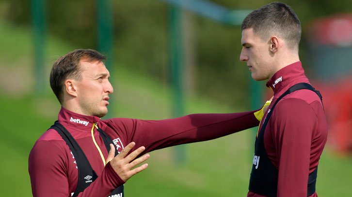 Mark Noble offers advice to young teammate Declan Rice on the training pitch