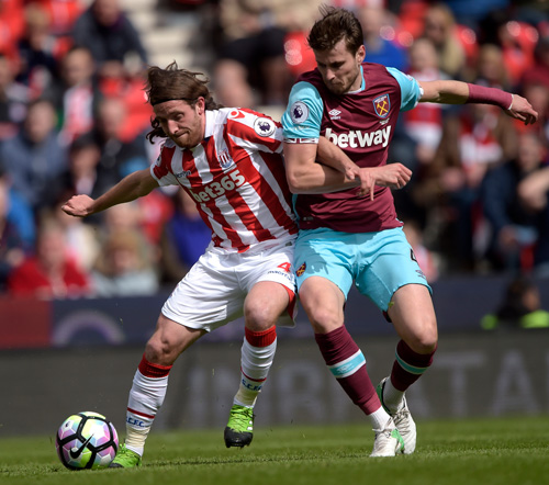 Havard Nordtveit battles for possession against Stoke City