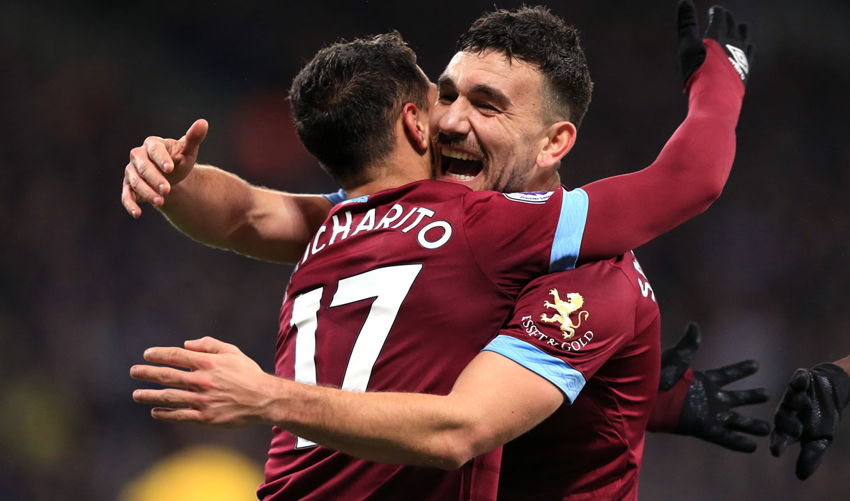 Chicharito celebrates with Robert Snodgrass