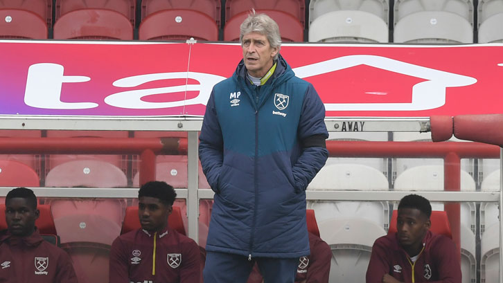 Manuel Pellegrini watches on at Griffin Park