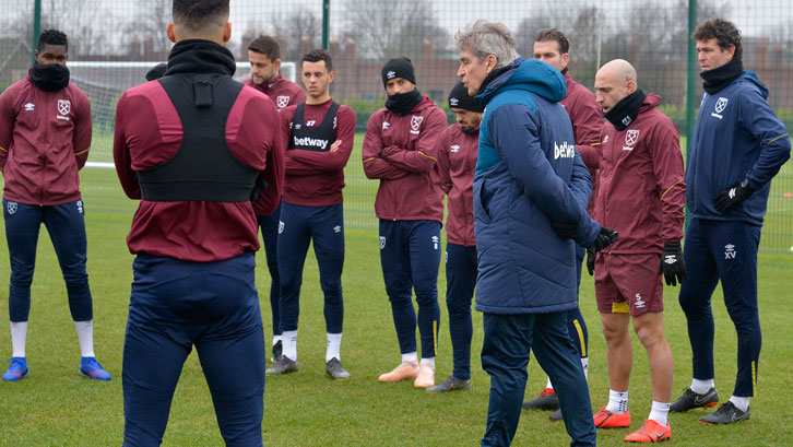 Manuel Pellegrini talks to his squad ahead of training at Rush Green