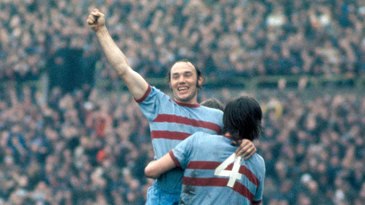 Pop Robson celebrates a goal with Billy Bonds