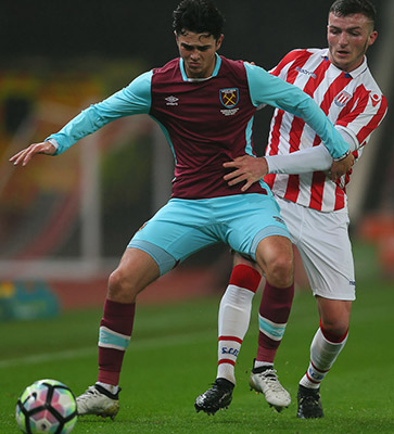 Joe Powell battles for possession against Stoke City