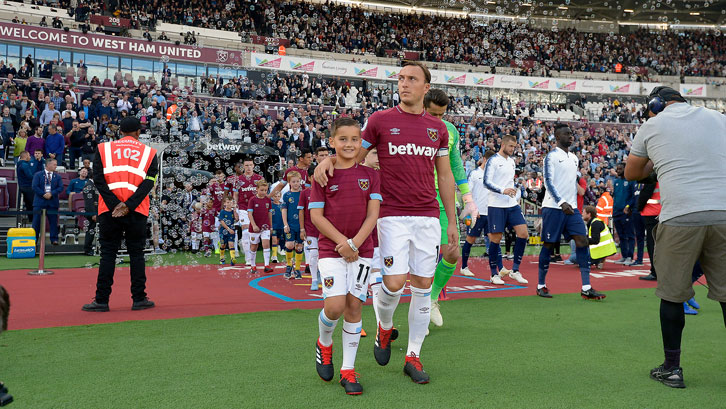 Ralphy Orsini and Mark Noble lead out the Hammers at London Stadium