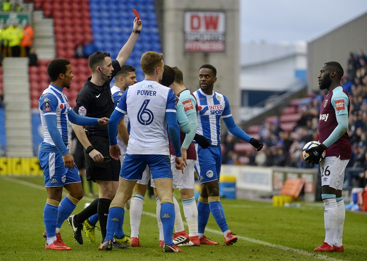 Arthur Masuaku is shown the red card by referee Chris Kavanagh