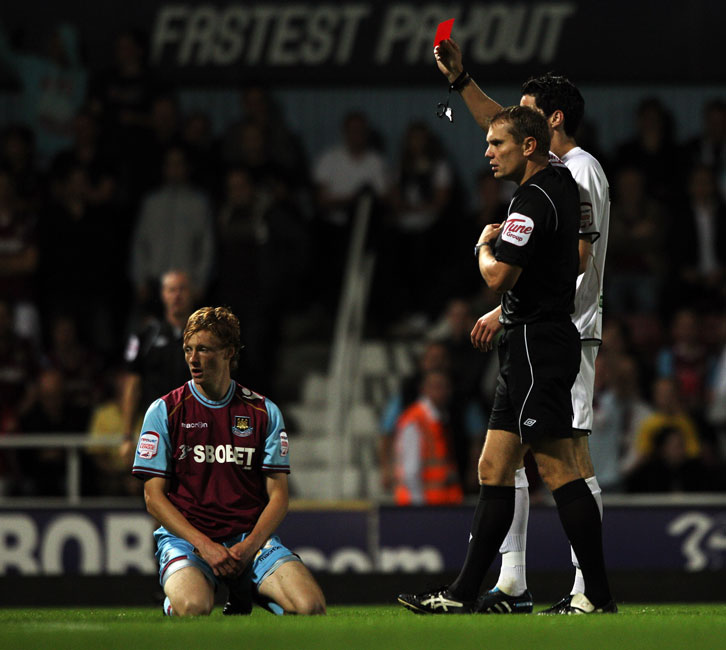 Callum McNaughton is shown the red card by referee Graham Scott